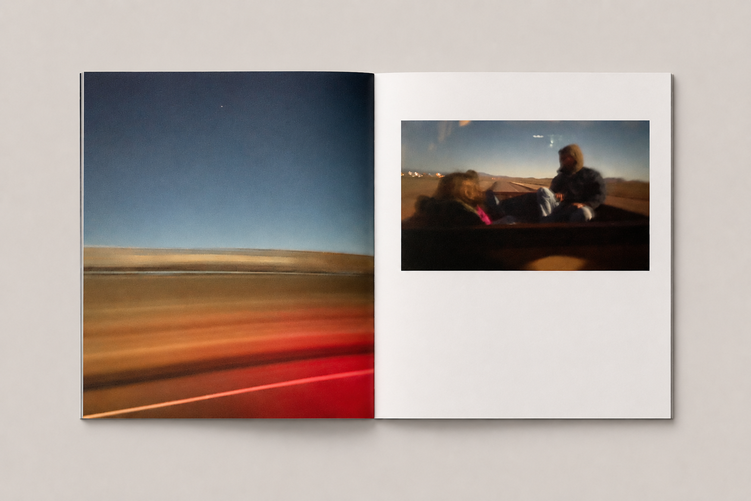 Open Passing By photo book spread with road blur and people in a truck bed